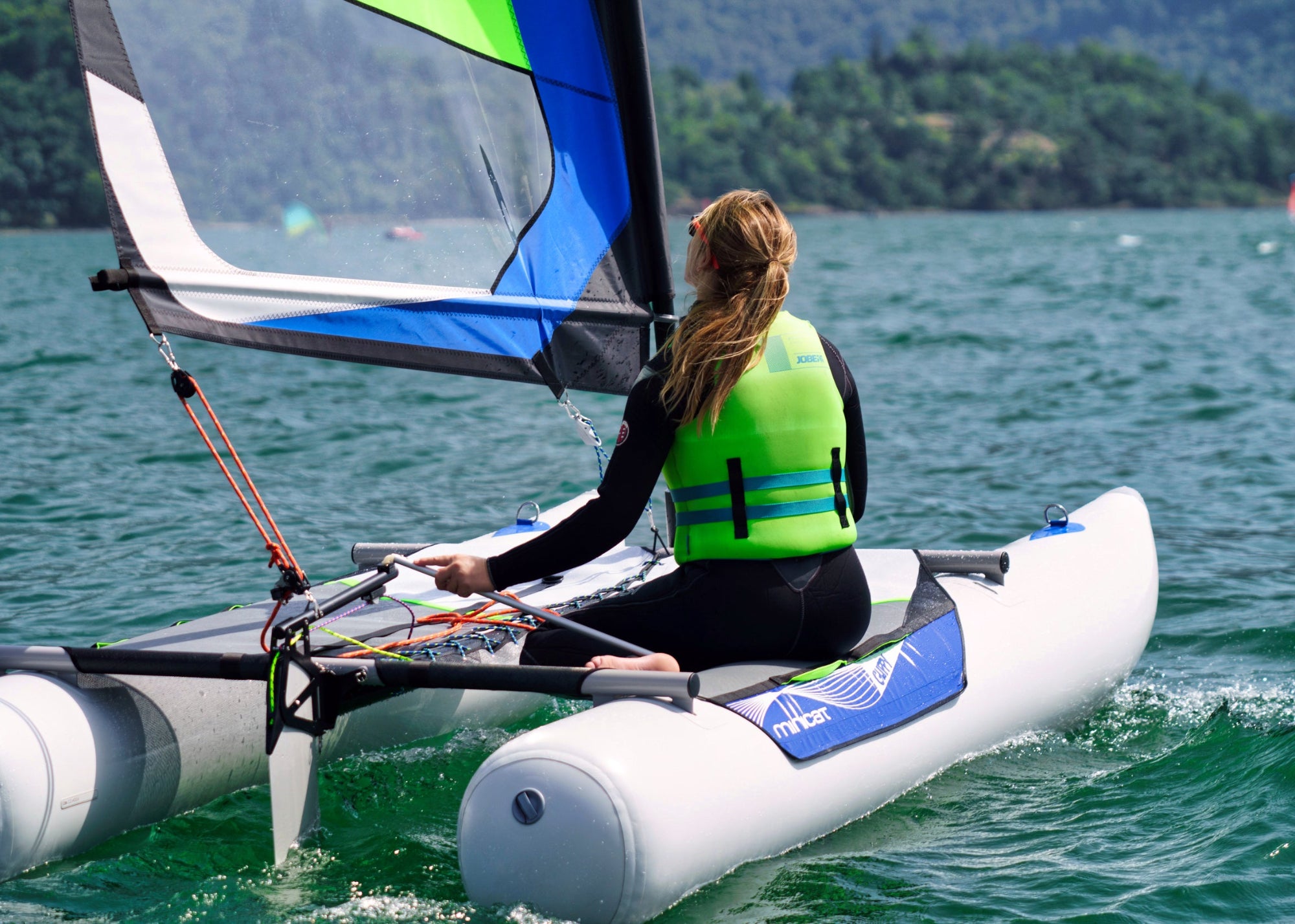 MiniCat Guppy sailboat sailing at the lake Como in Italy 