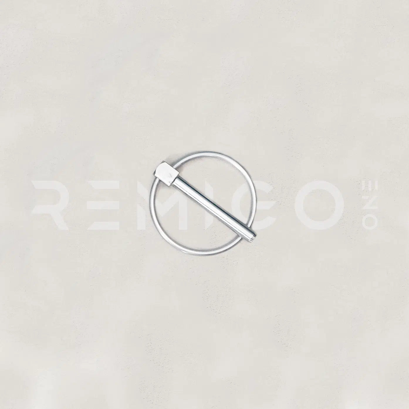 Silver ring with a stick-like object on a light gray background