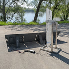 Solar panel system on a concrete surface with trees and water in the background
